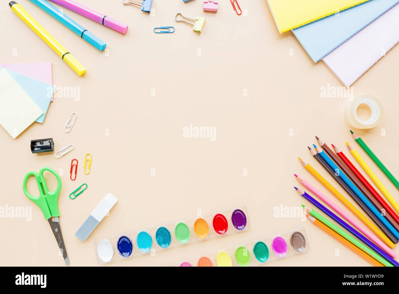 Orange back to school flat lay with bright stationery. School supplies ...