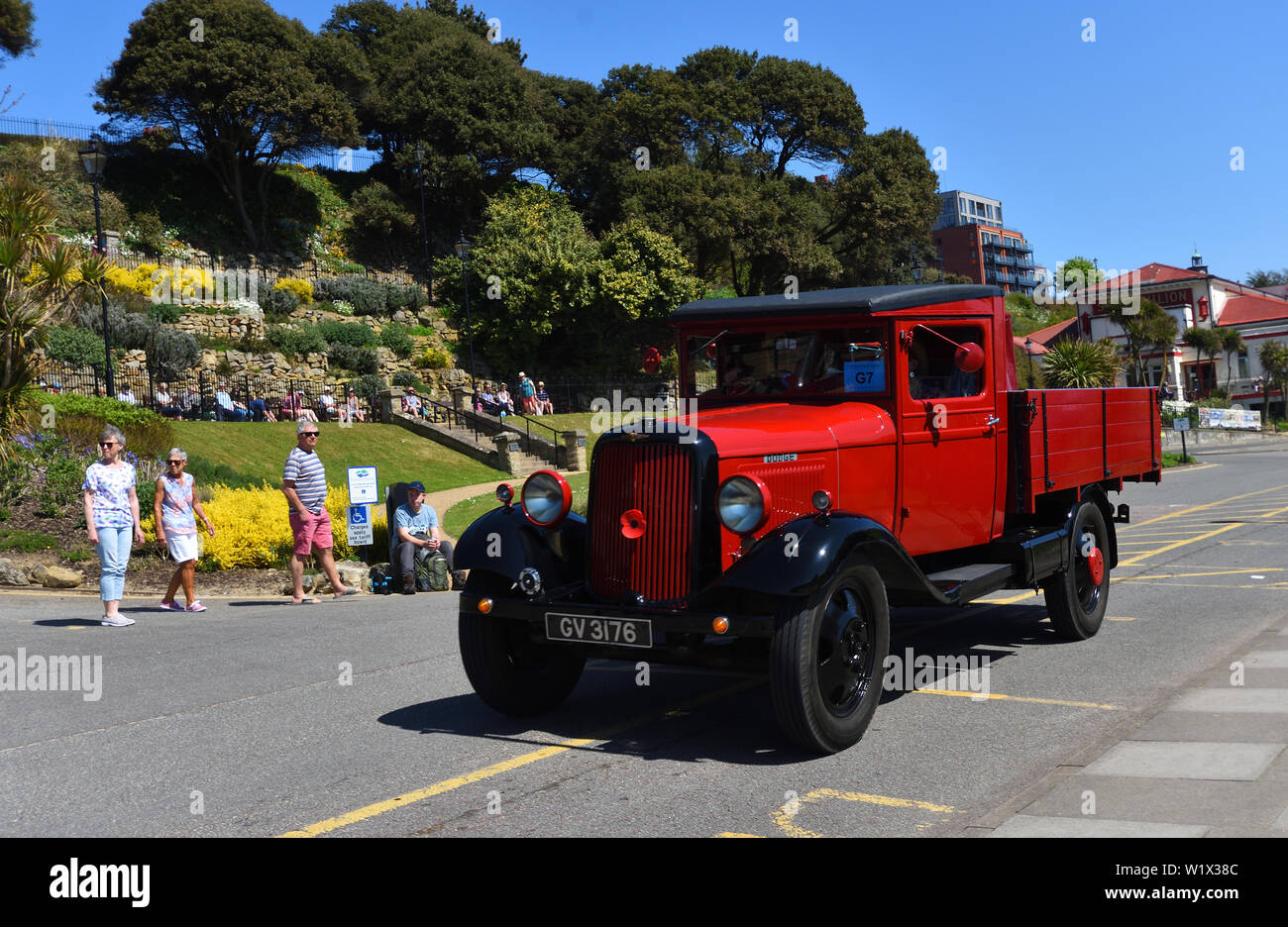 Vintage Red Dodge Truck being driven along promenade. Stock Photo