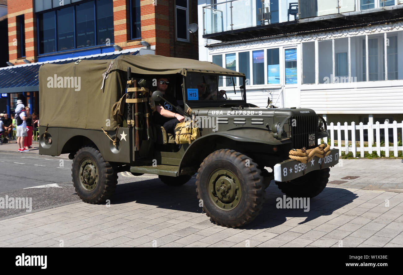 Vintage Small Army Truck being driven along street. Stock Photo