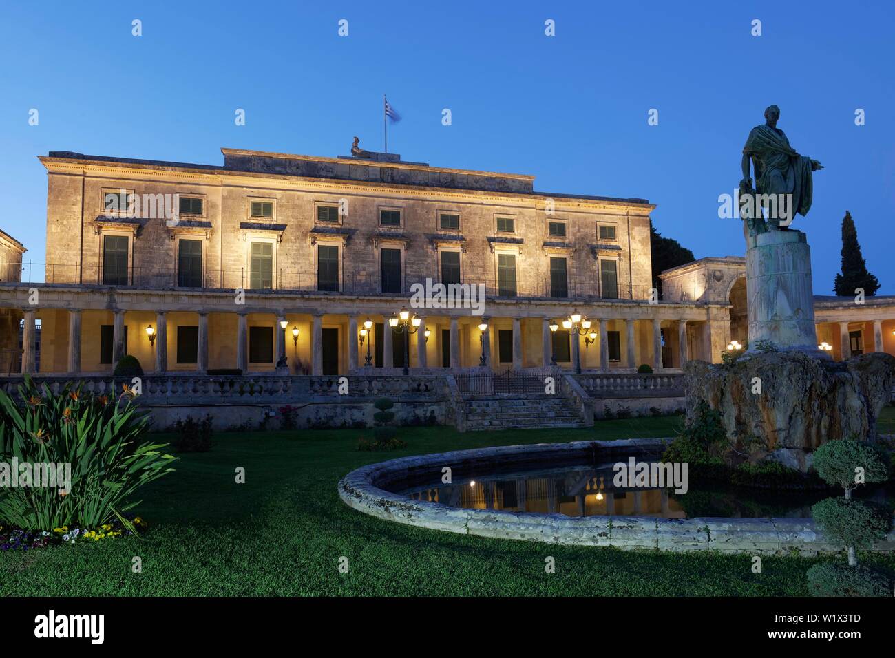 Illuminated Palace St. Michael and St. George, also Old Palace, in front Sir Frederic Adam Statue, Dusk, Corfu City, Island Corfu, Ionian Islands Stock Photo