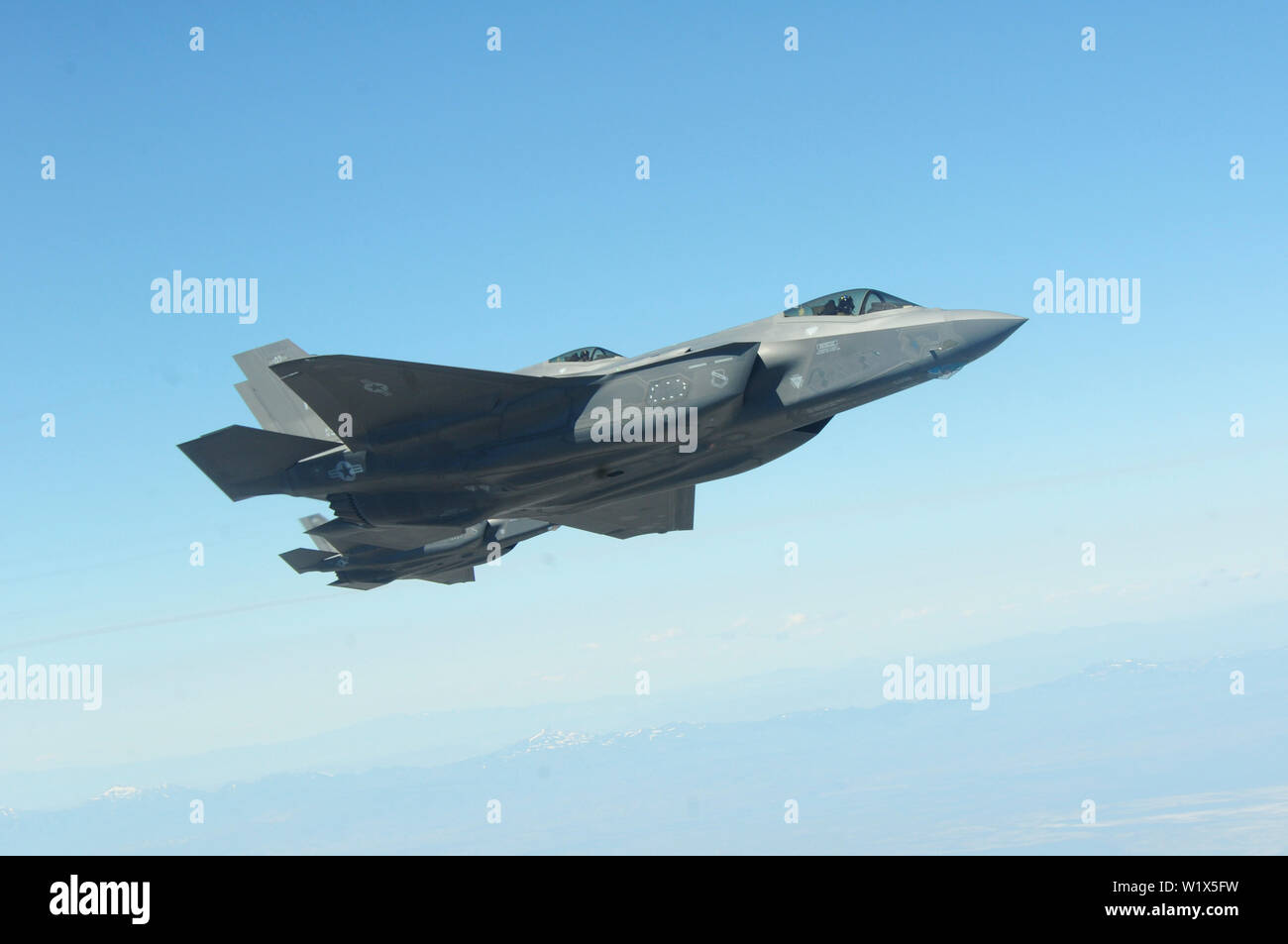 F-35 Lightning II’s, assigned to Hill Air Force Base, Utah, fly alongside a Utah Air National Guard KC-135R Stratotanker during a refueling mission June 27, 2019 above the skies of Nev. Due to their close proximity, units from Hill AFB and the Utah Air National Guard routinely participate in refueling missions with one another. (U.S. Air National Guard photo by Staff Sgt. Danny Whitlock) Stock Photo