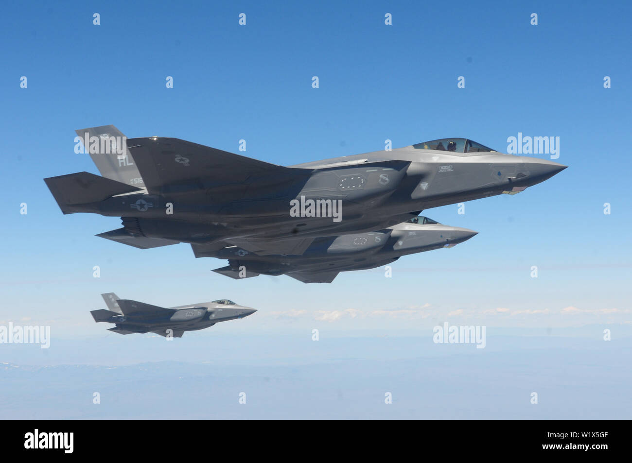 F-35 Lightning II’s, assigned to Hill Air Force Base, Utah, fly alongside a Utah Air National Guard KC-135R Stratotanker during a refueling mission June 27, 2019 above the skies of Nev. Due to their close proximity, units from Hill AFB and the Utah Air National Guard routinely participate in refueling missions with one another.(U.S. Air National Guard photo by Staff Sgt. Danny Whitlock) Stock Photo