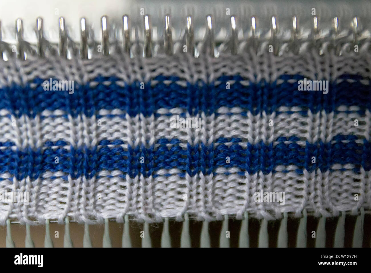 Manual knitting machine. A knitting machine is a device used to create