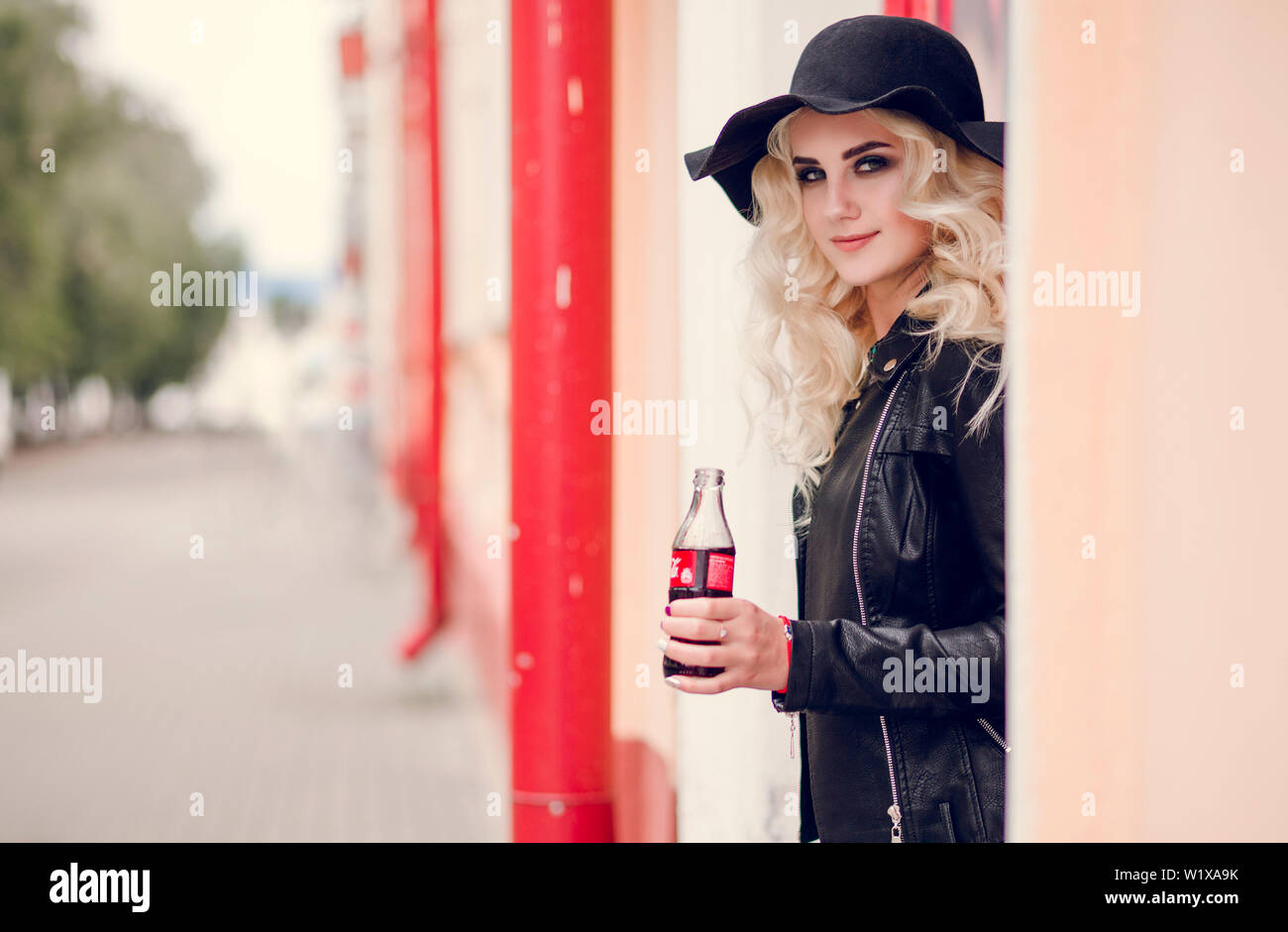 Minsk, Belarus - September 26, 2018. Photo of Fashionable adult girl with a bottle of coca-cola in their hands Stock Photo