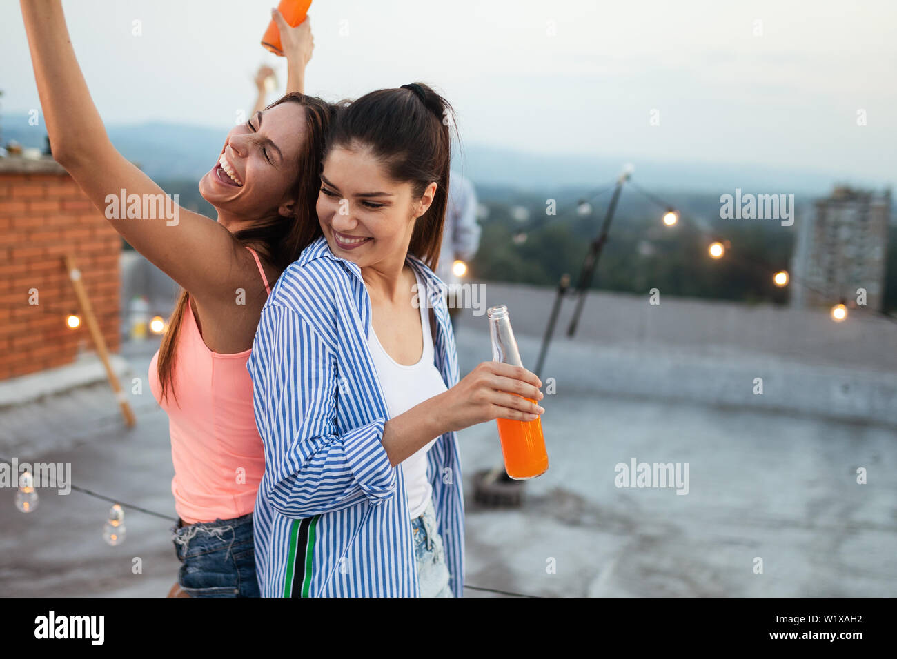 Happy young girls having fun at party Stock Photo - Alamy
