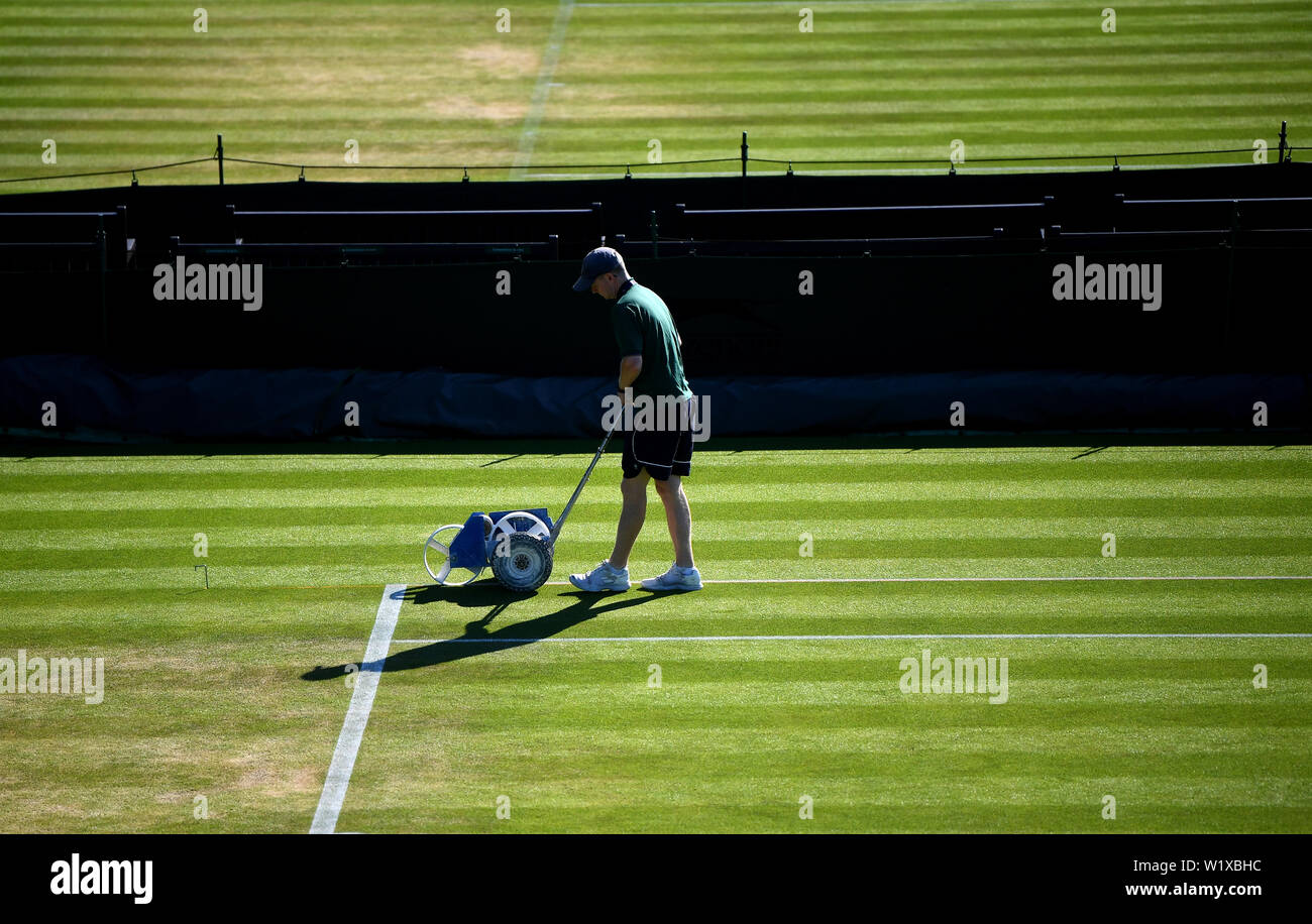 Ground-Staff prepare the outside courts ahead of day four of the Wimbledon Championships at the All England Lawn Tennis and Croquet Club, Wimbledon. Stock Photo