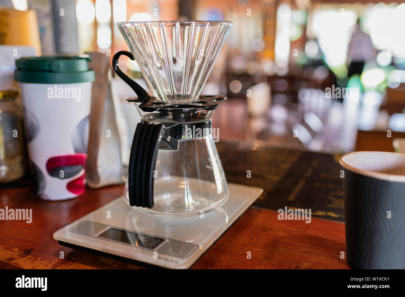 Measuring coffee drip with glass mug on counter bar Stock Photo