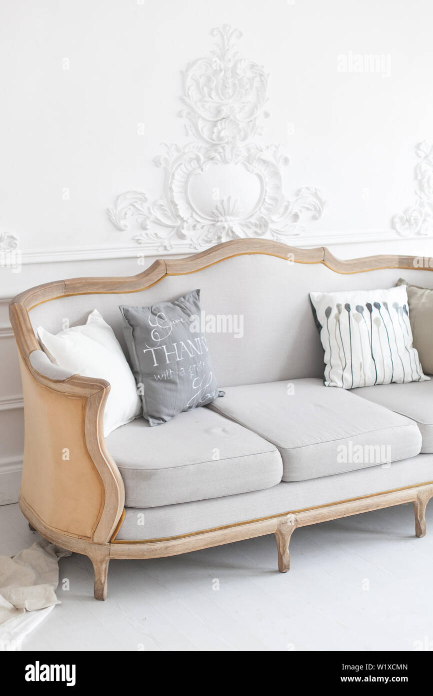 Set of pillows on classic sofa in modern living room interior. Stock Photo
