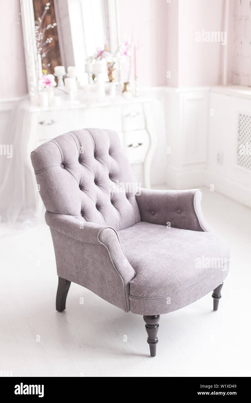 Gray vintage chair in the luxurious interior of the living room. Soft