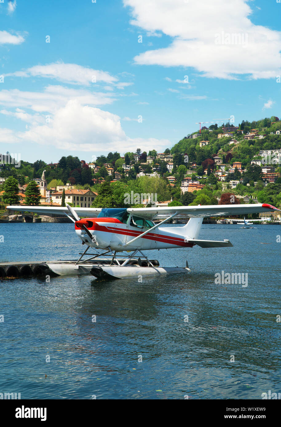 Red floatplane or seaplane moored on Como lake. Stock Photo