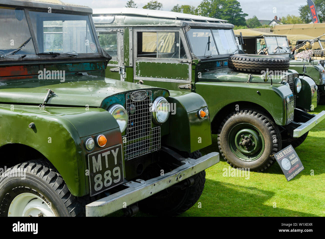 Restored green Land Rover Series 1 88' 1957 4X4 parked by Series One 107' LWB station wagon 1958 - Classic Vehicle Show, Burley in Wharfedale, England Stock Photo