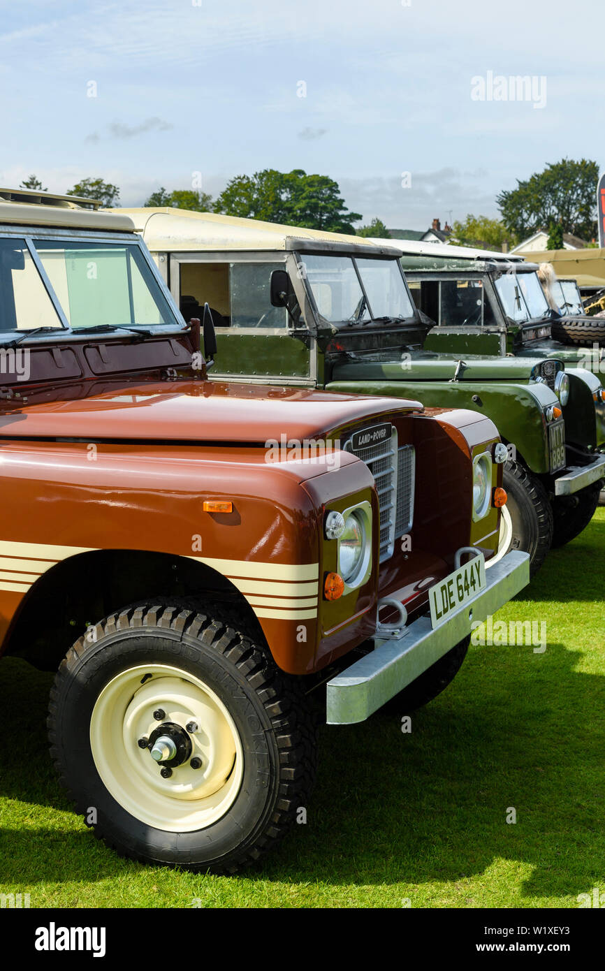 Iconic series Land Rovers parked (brown 1982 Series 3 Land Rover County Station Wagon at front) - Classic Vehicle Show, Burley in Wharfedale, England. Stock Photo