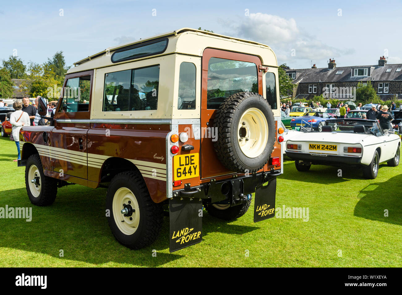 Iconic series Land Rover parked on display (russet brown 1982 Series 3 County Station Wagon) - Classic Vehicle Show, Burley in Wharfedale, England, UK Stock Photo