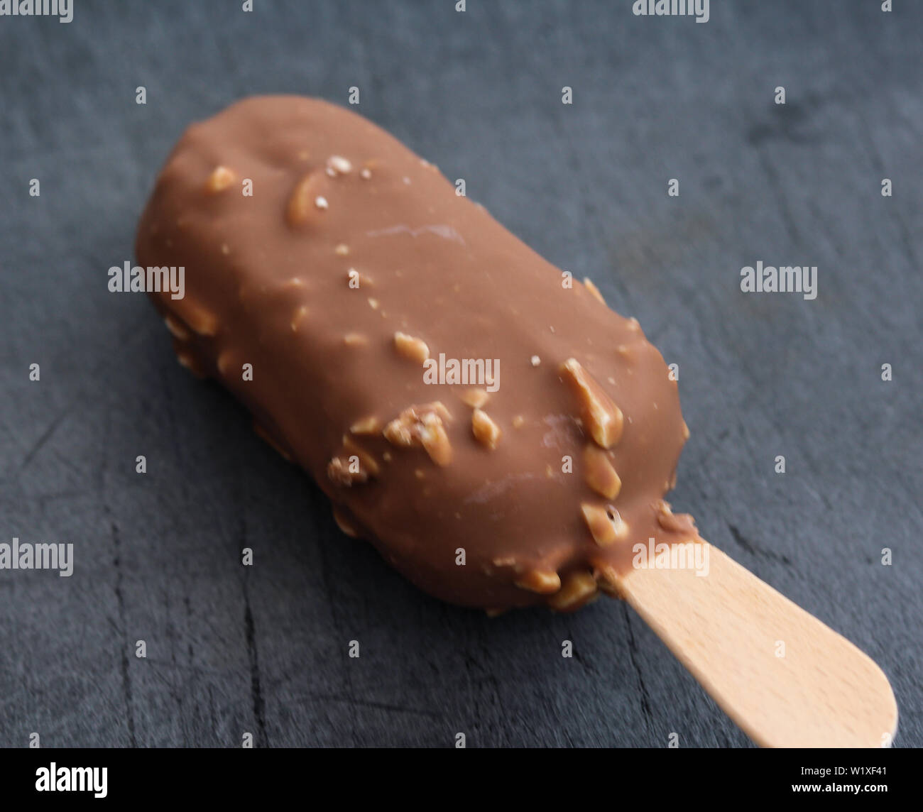 close up of Vanilla milk chocolate almond bar ice cream on black