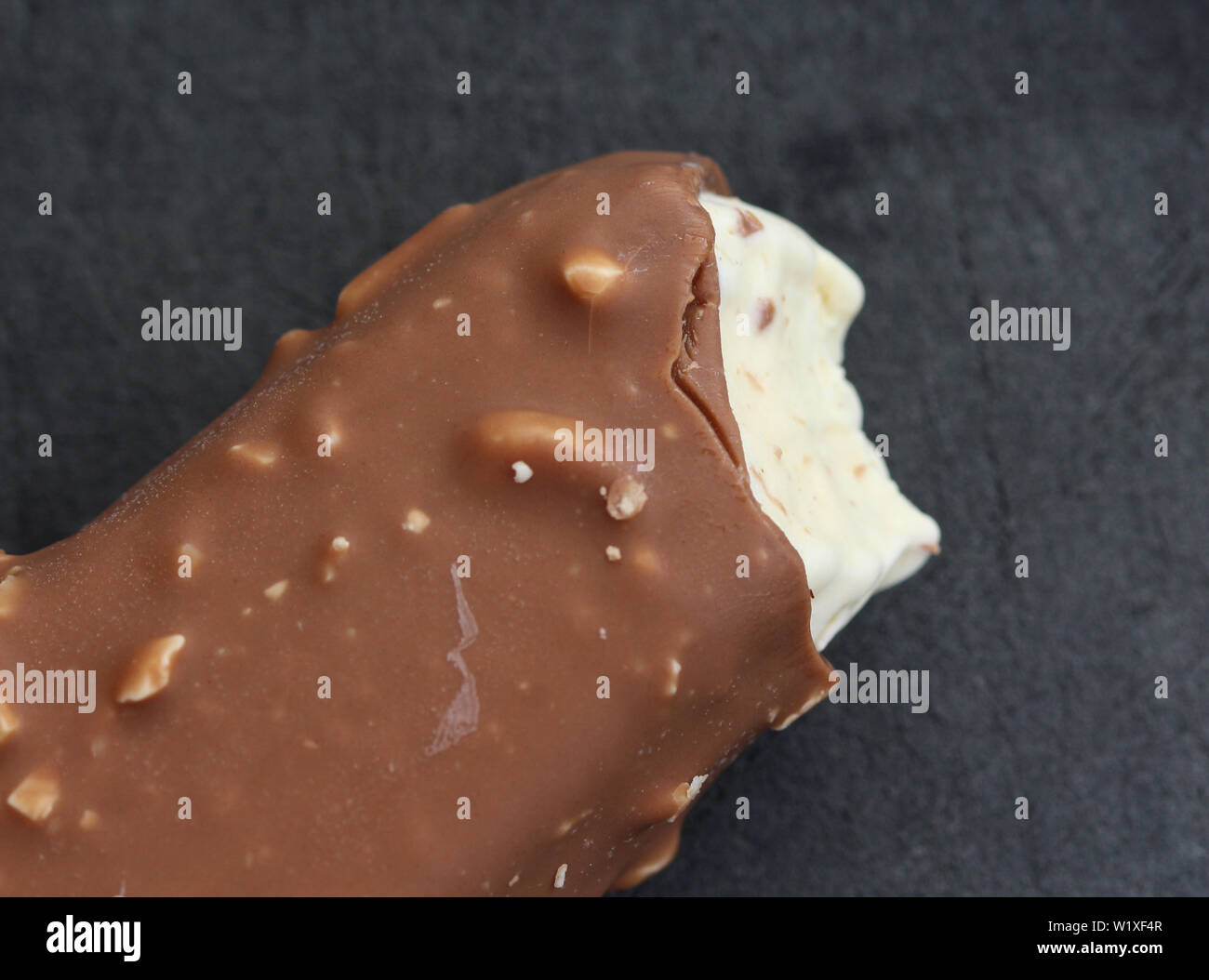 close up of Vanilla milk chocolate almond bar ice cream on black