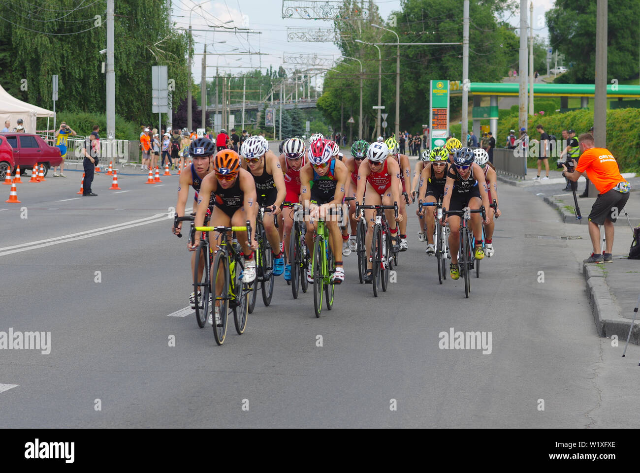 DNIPRO, UKRAINE - JUNE 08, 2019: Group of female athletes on a bicycle section on a city street during of the '2019 Dnipro ETU Sprint Triathlon Europe Stock Photo