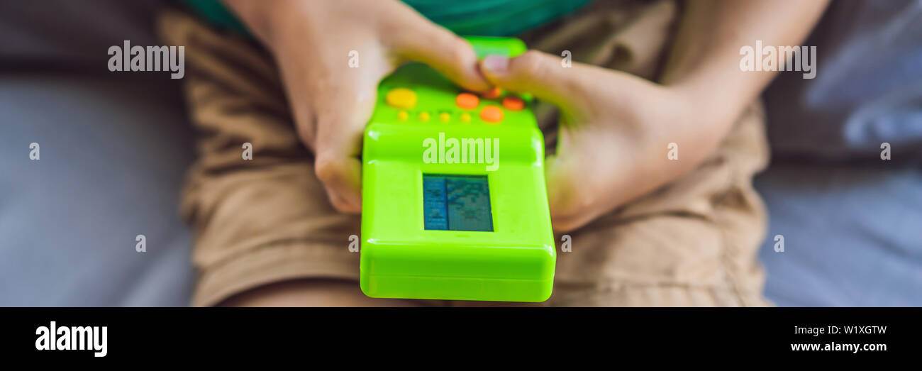Young Boy Playing Old School Portable Game Console Electronic