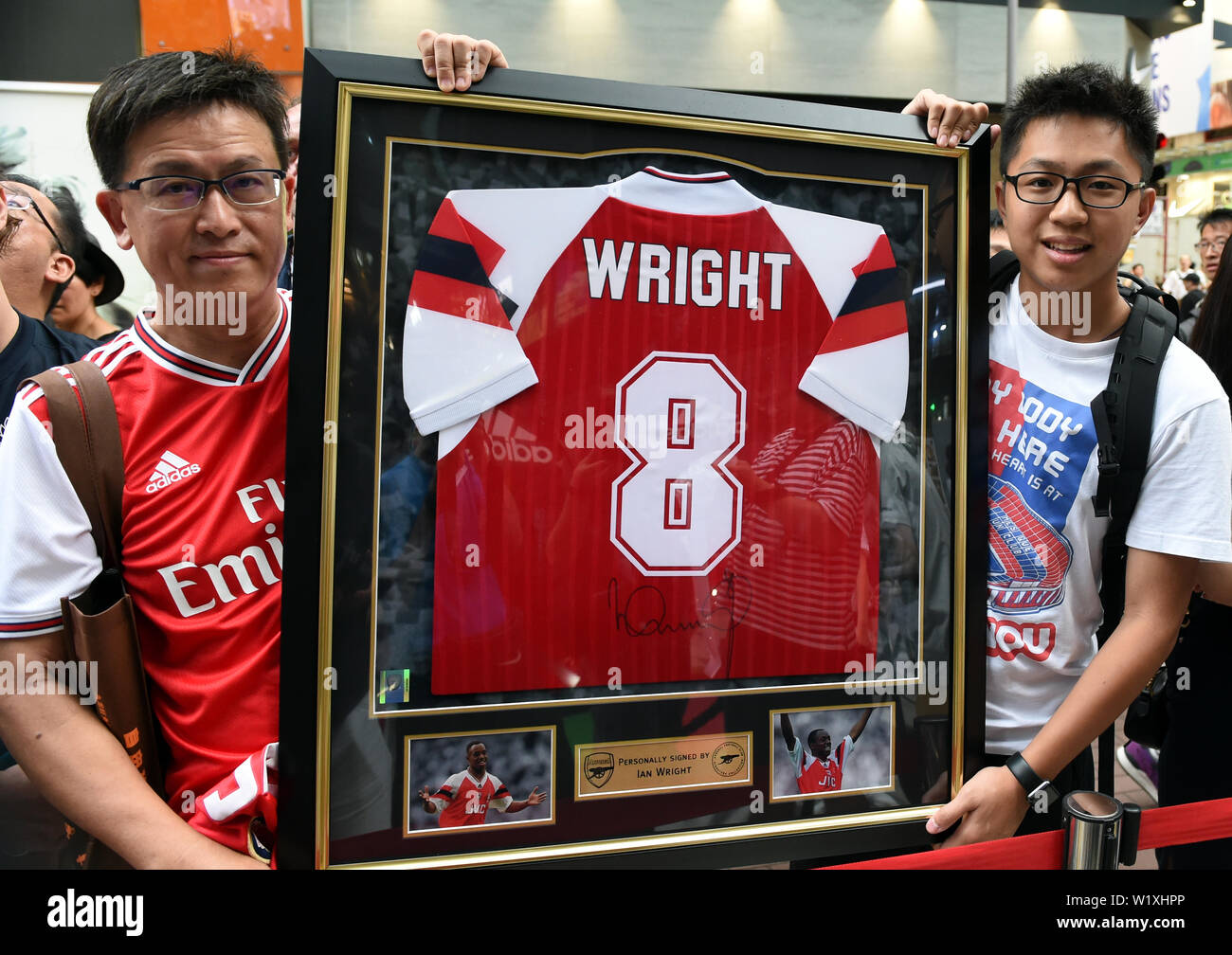 Fans show a team jersey of former English football player Ian Wright during  a promotional event for new team jersey of Arsenal F.C. of English football  league system at a sportswear store