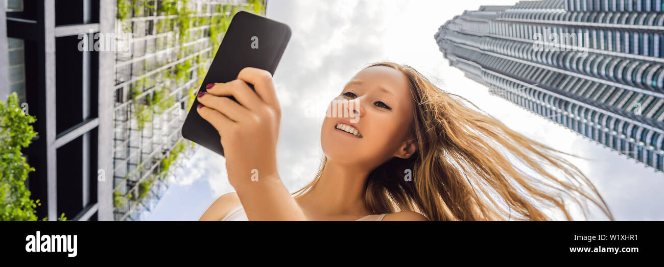 Woman Using Map App On Smartphone On The Background Of Skyscrapers