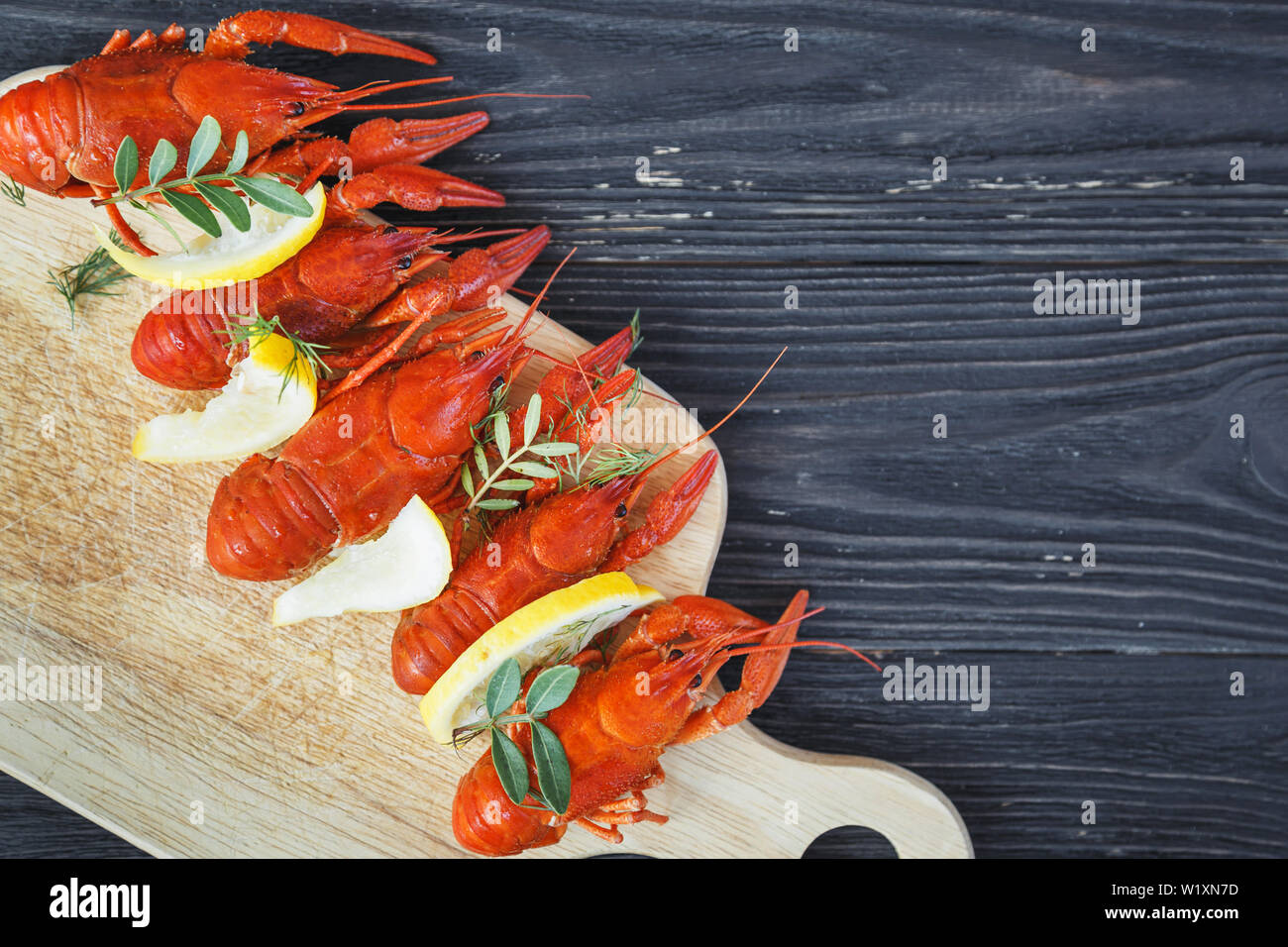 Close-up of boiled crawfish with lemon and green Stock Photo