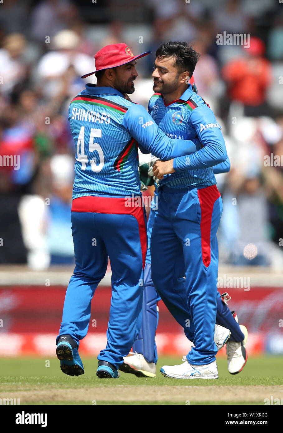 Afghanistan's Rashid Khan (right) celebrates the wicket of West Indies' Evin Lewis (not pictured) with team-mate Samiullah Shinwari during the ICC cricket World Cup group stage match at Headingley, Leeds. Stock Photo