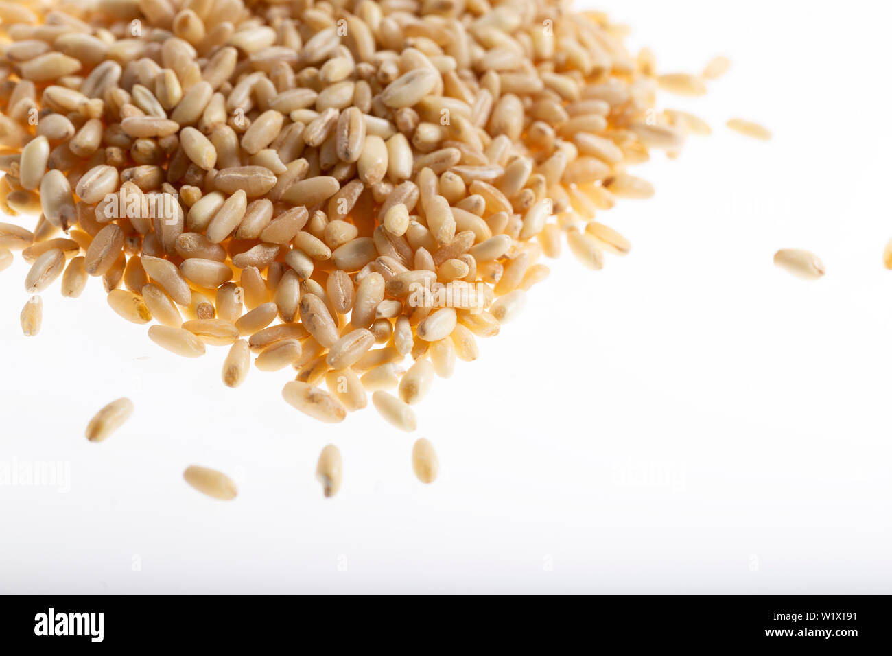 Pile of wheat grain isolated on white background Stock Photo - Alamy