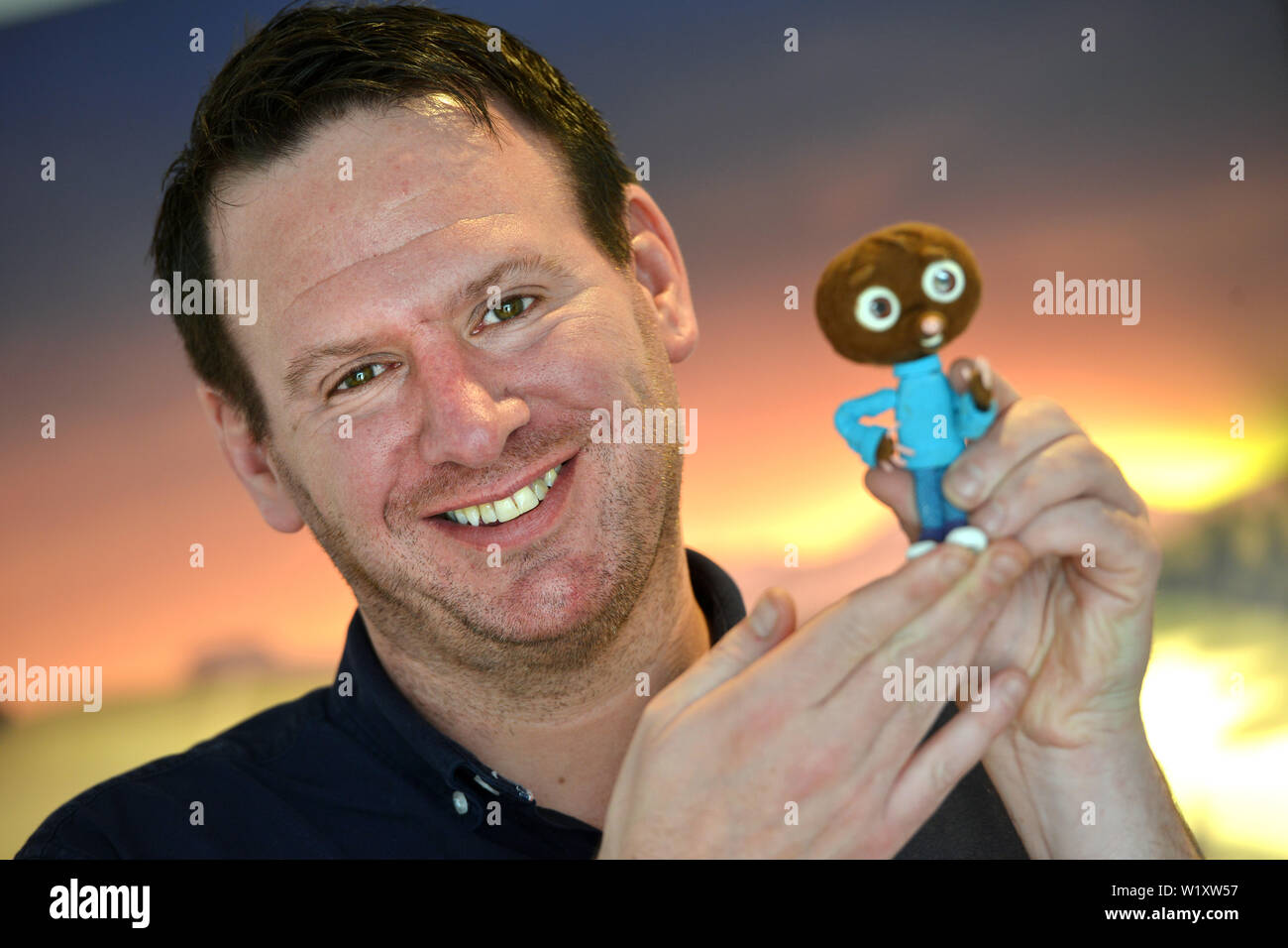 Writer Neil James with character 'Strike' from the 2018 stop motion