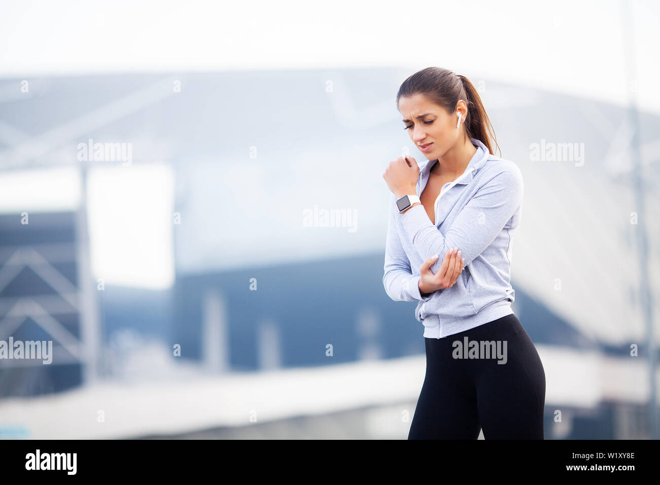 Fitness. Woman have accident injury and hurt at arms while workout at