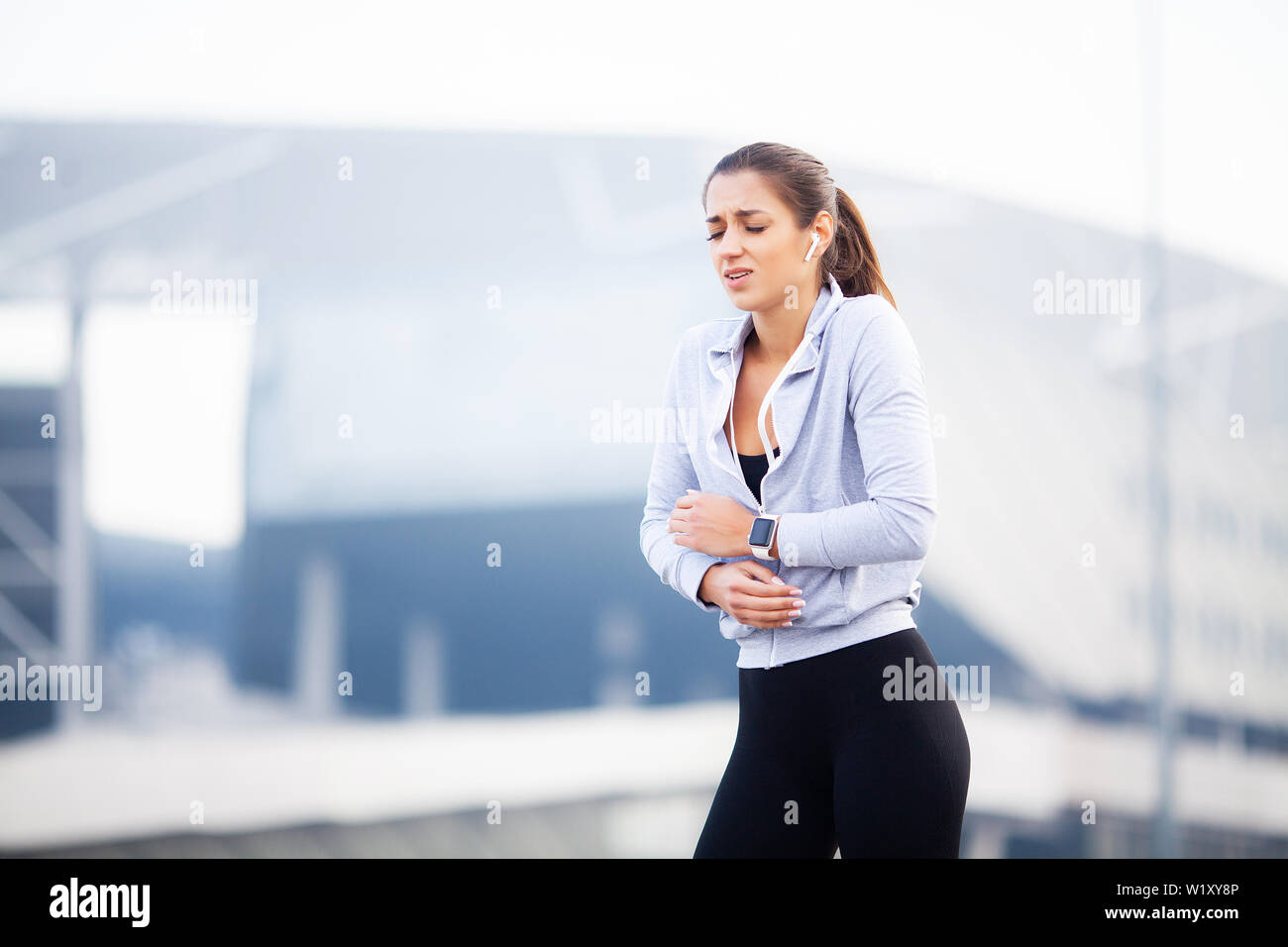 Fitness. Woman have accident injury and hurt at arms while workout at