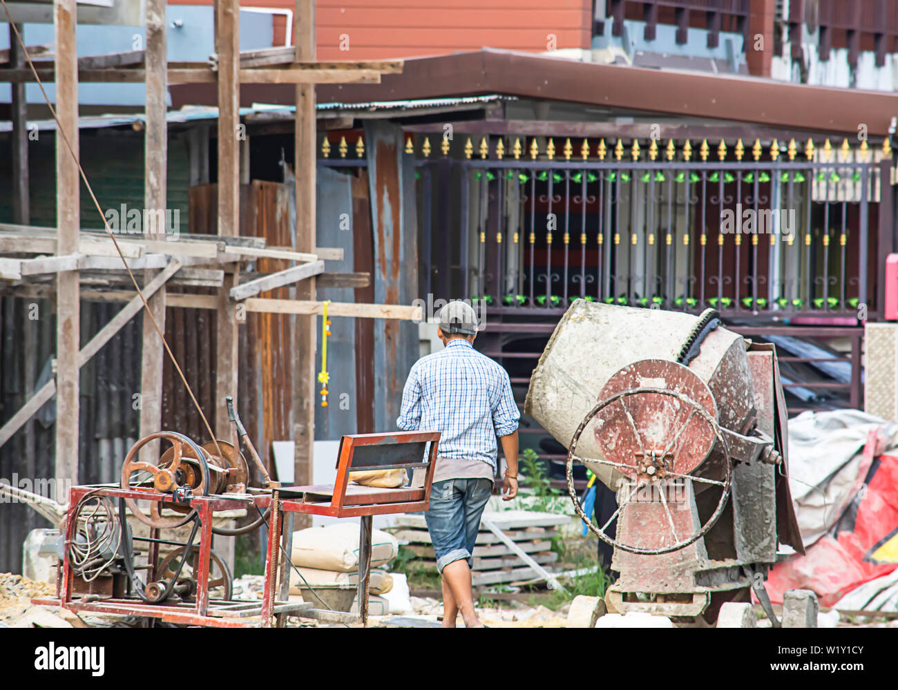 The workers are mixing cement in a cement mill. Stock Photo