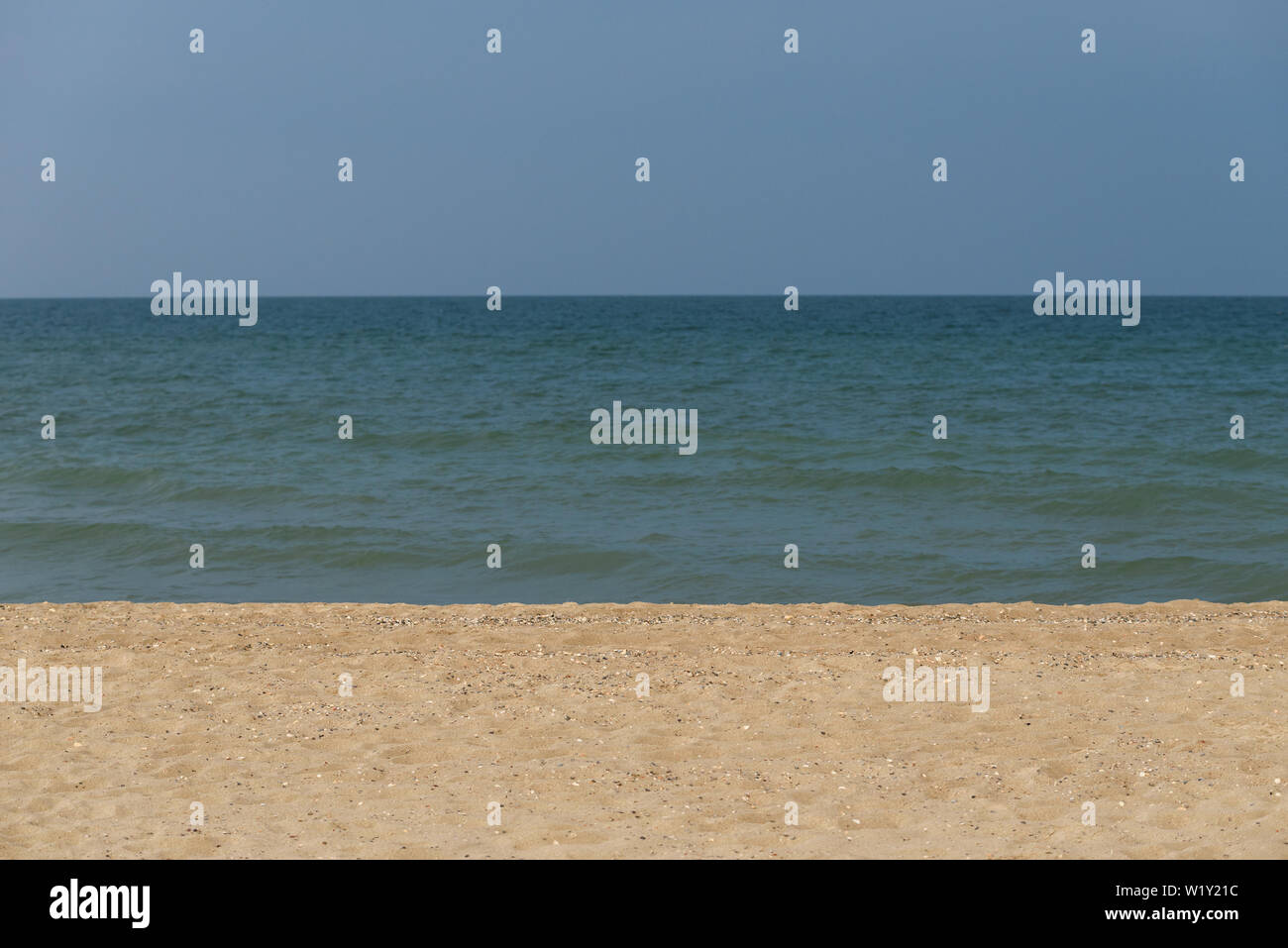 Abstract seascape. Summer background for design on the theme of the sea resort. Sky, water and sandy beach Stock Photo