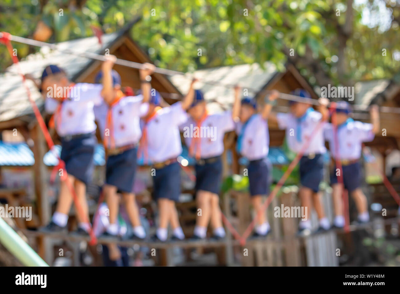 Blurred Children walking on the wire rope are doing the activity. Stock Photo