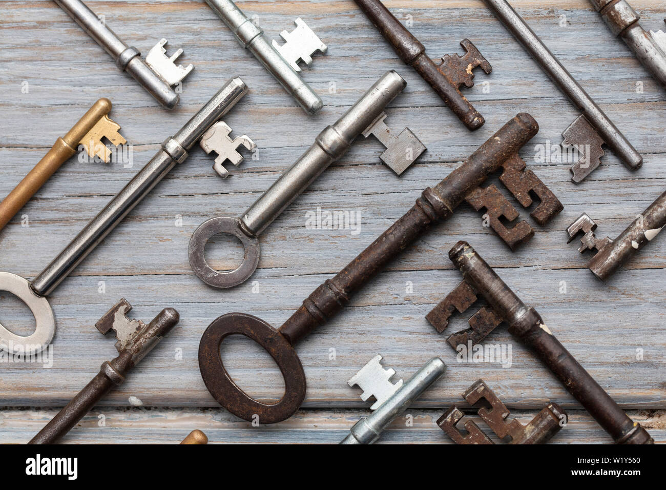 Vintage old fashioned keys on a rustic wooden background. Security concept Stock Photo