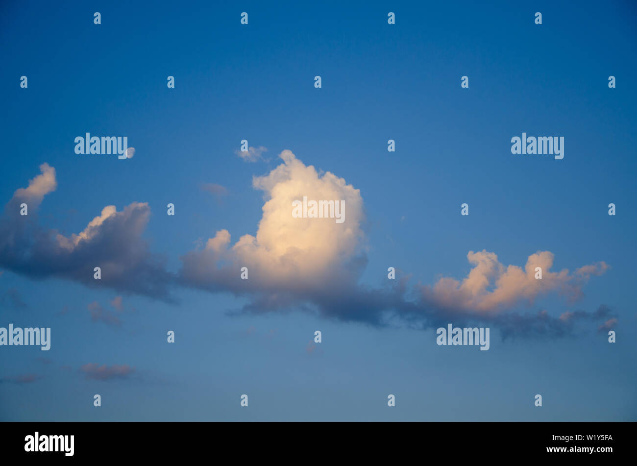Blue sky background with cumulus clouds at sunrise Stock Photo