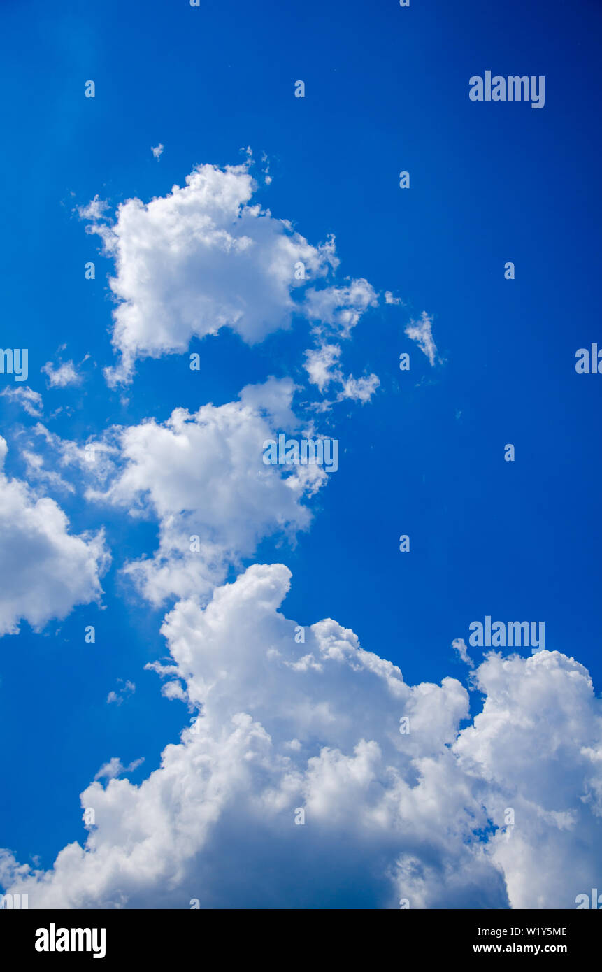 Blue sky background with white cumulus clouds Stock Photo