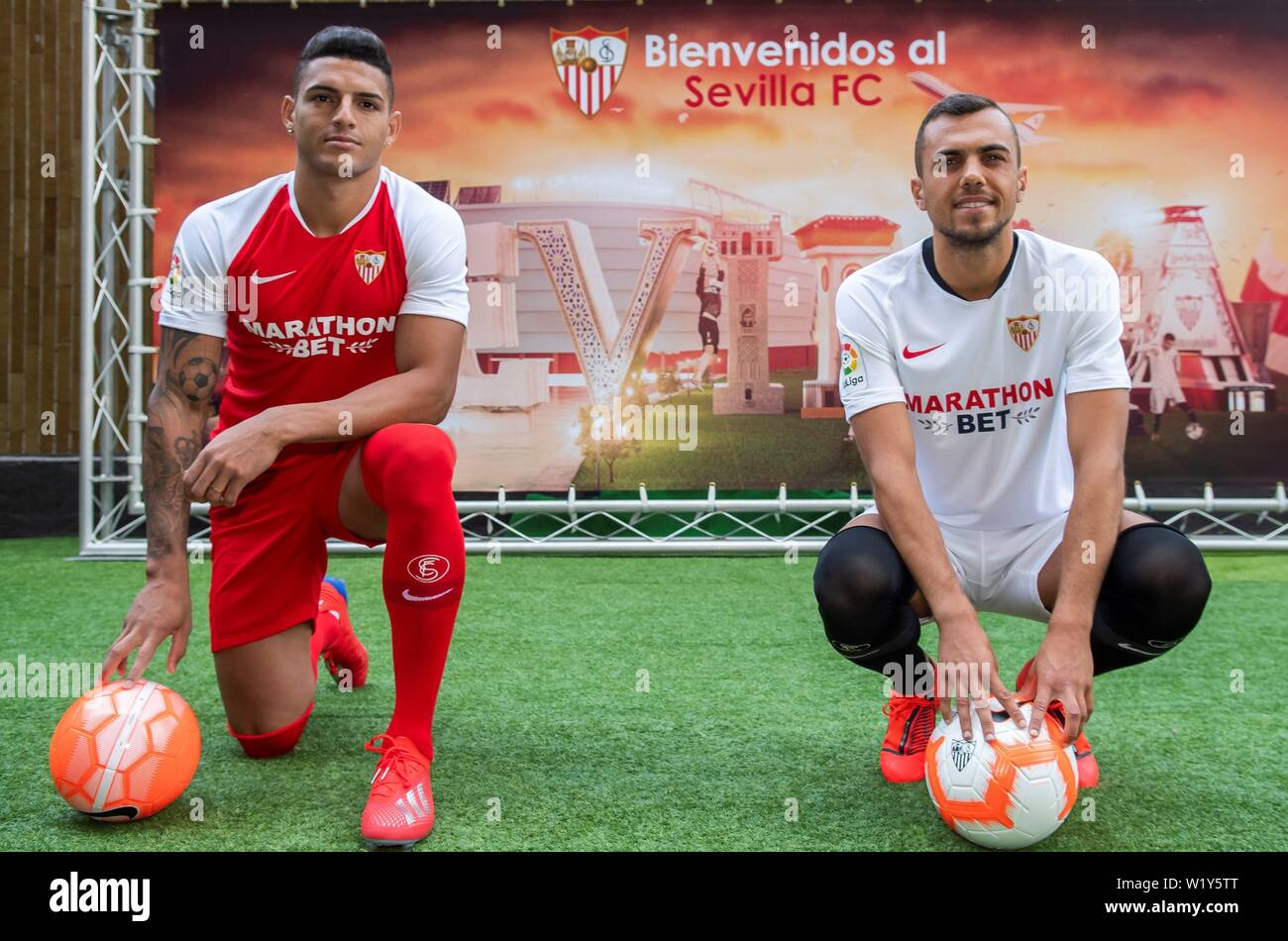 Seville, Spain. 04th July, 2019. Spanish midfielder Joan Jordan (R) and  Brazilian defender Diego Carlos pose for the photographers during their  presentation as new players of Sevilla FC, in Seville, southern Spain,