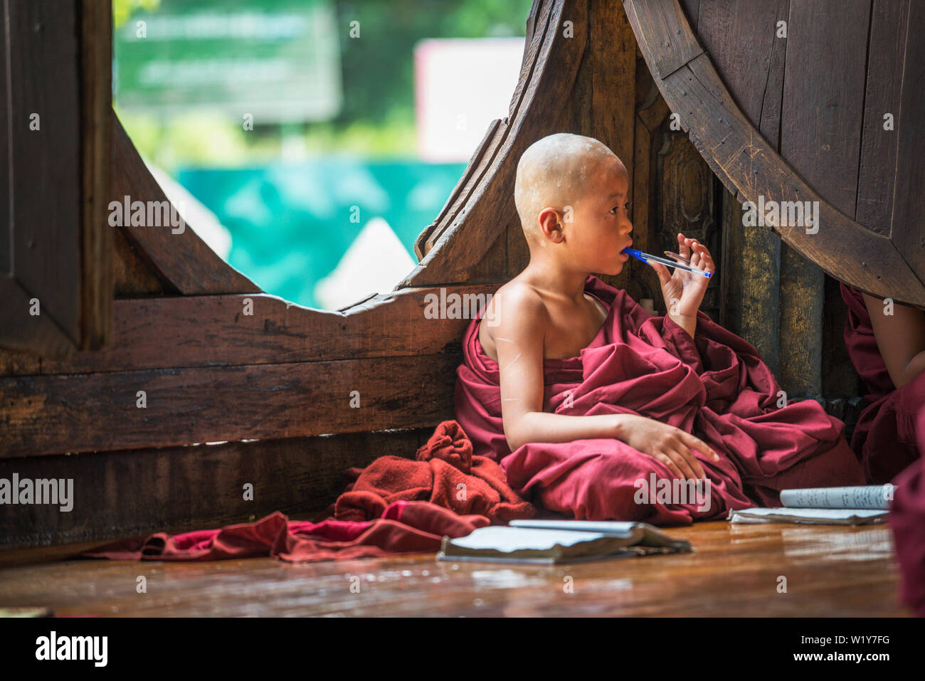 Asian child monk learning from his school book Stock Photo