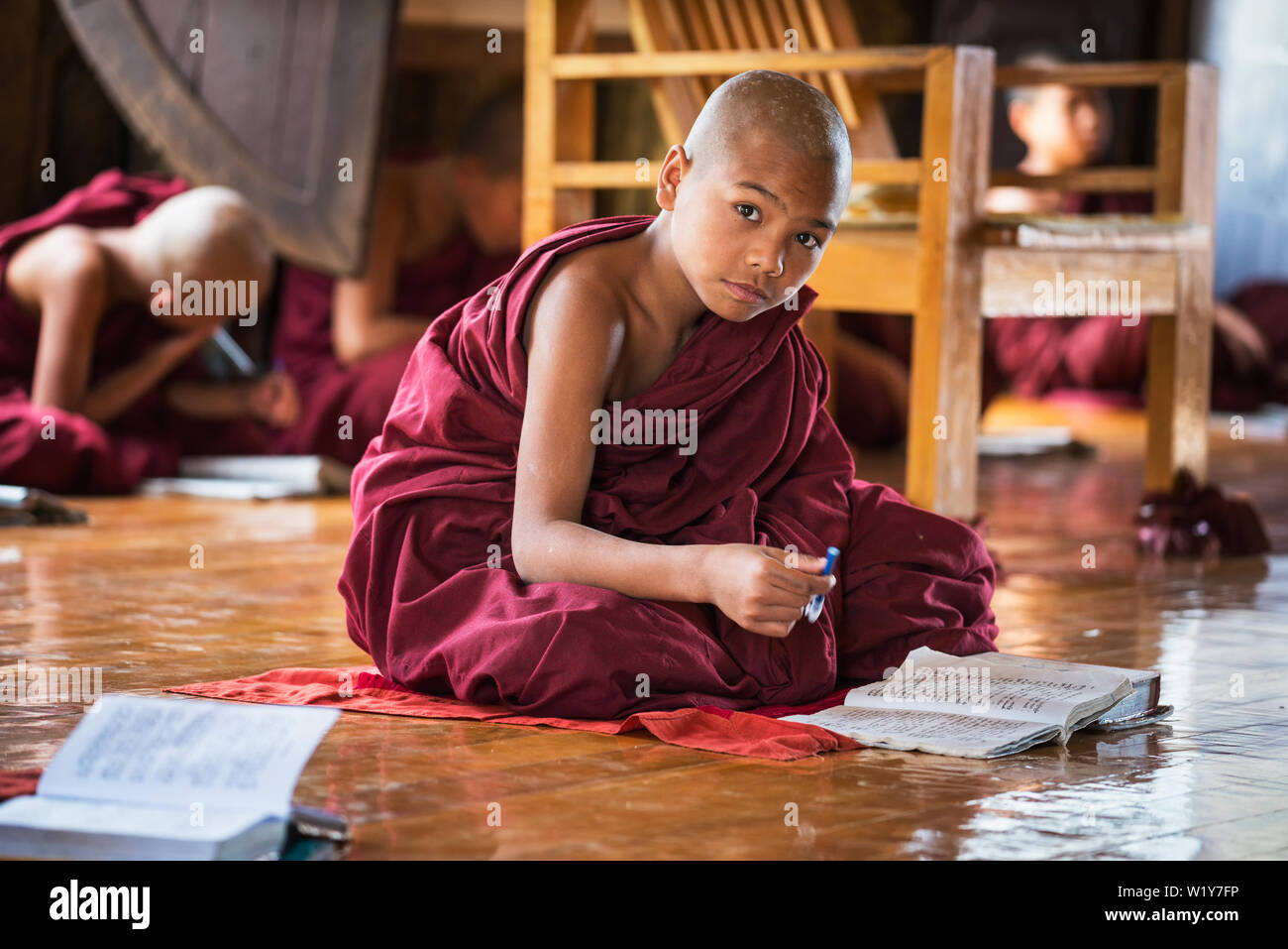 Asian child monk learning from his school book Stock Photo