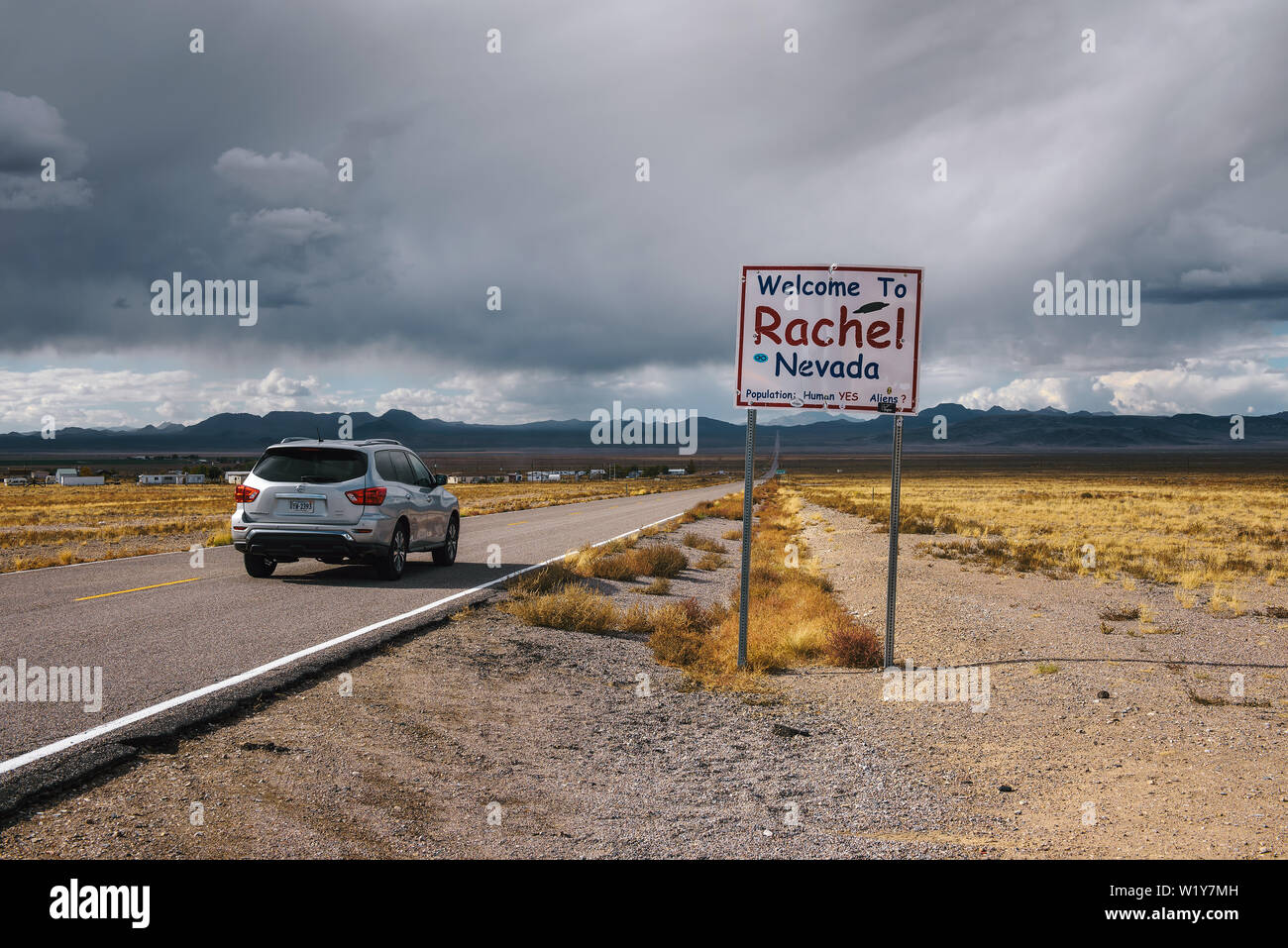 Car passing the Welcome to Rachel street sign on SR-375 in Nevada Stock Photo