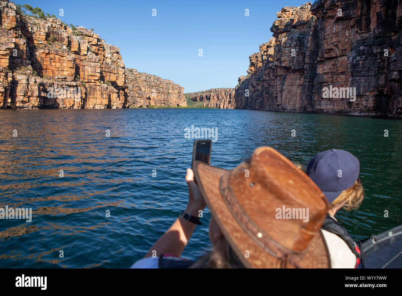 low angel view from people sitting in a zodiac boat cruising down  the King George River in the Kimberleys in Western Australia, with a unrecognizable Stock Photo