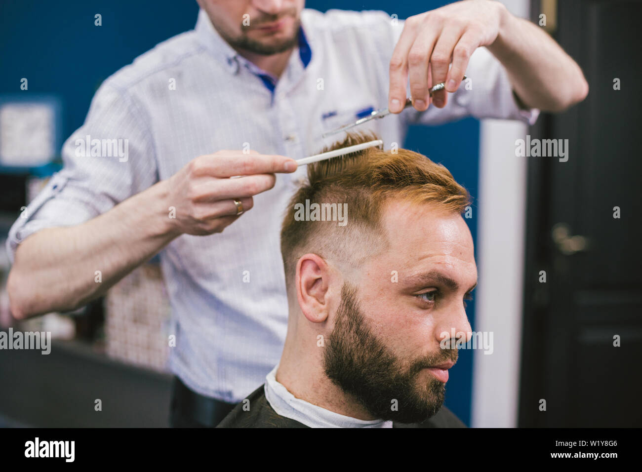 Barber Making Haircut Bearded Man In Barbershop