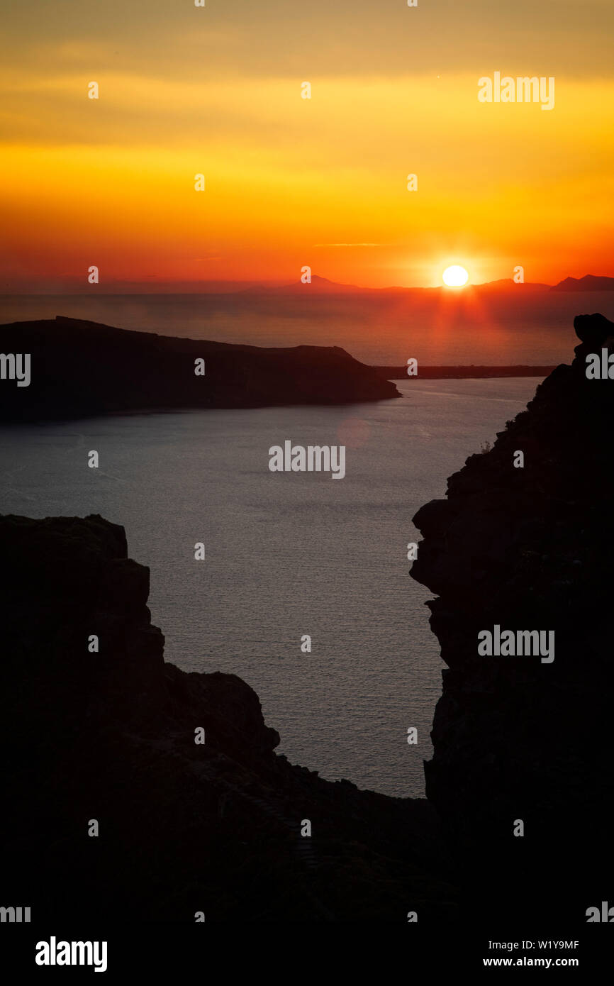 The sun sets over the Aegean Sea at Santorini, Greece. Stock Photo
