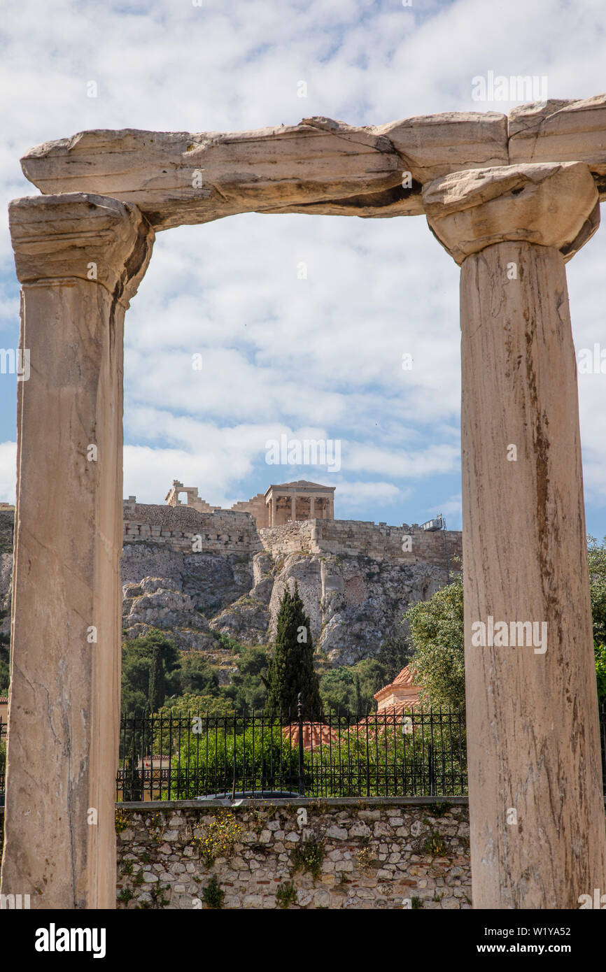 A few columns still stand at Hadrians Library and frame the Acropolis above in Athens, Greece. Stock Photo