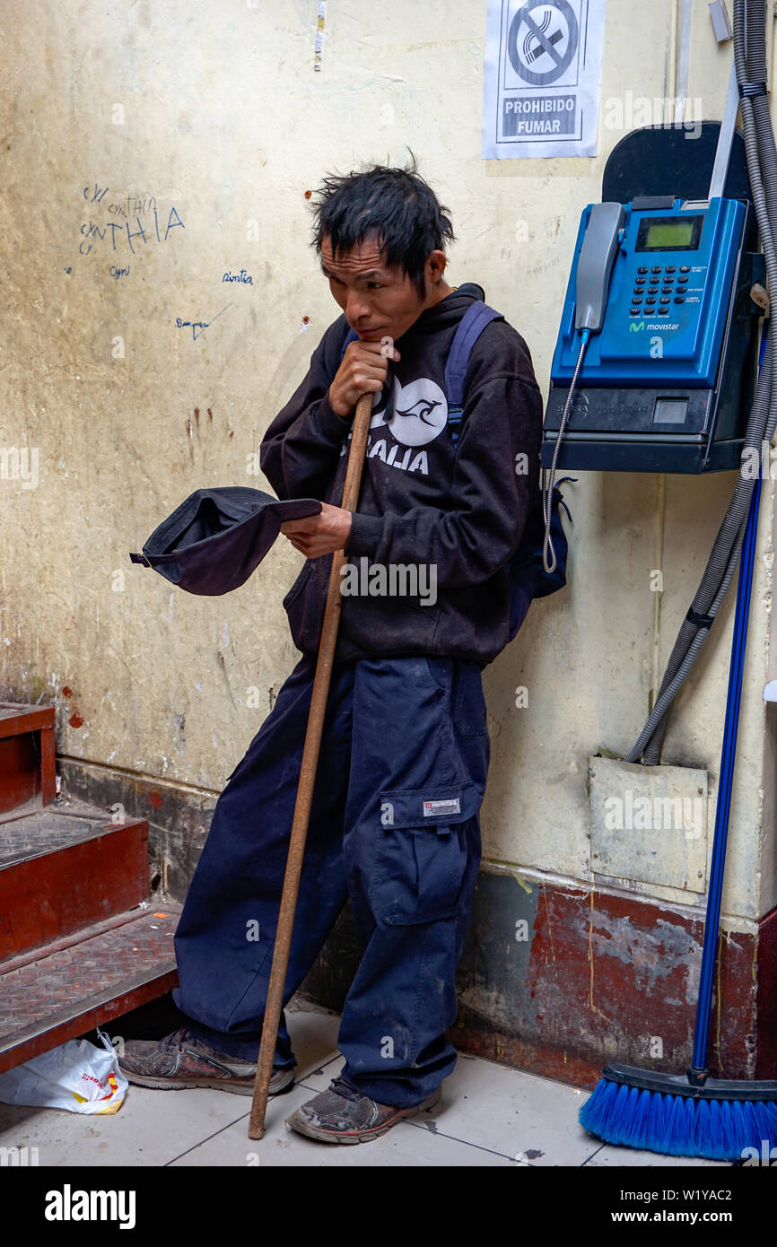 Huaraz, Ancash / Peru - 4. June, 2016: a poor blind local Indio beggar next to public phone begging for alms in the market of Huaraz in Peru Stock Photo