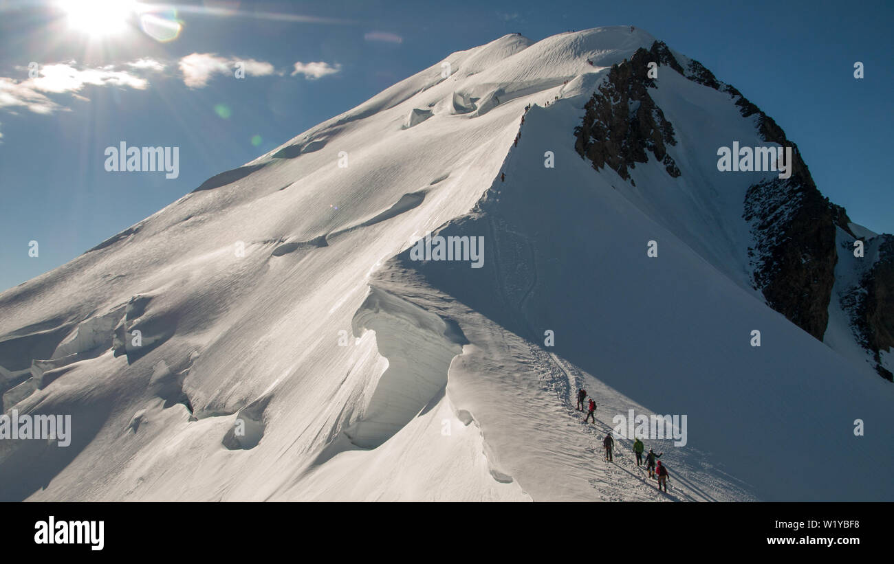 Alpinists climbing the highest mountain in Western Europe. Mont Blanc (French) or Monte Bianco (Italian), France and Italy. Stock Photo