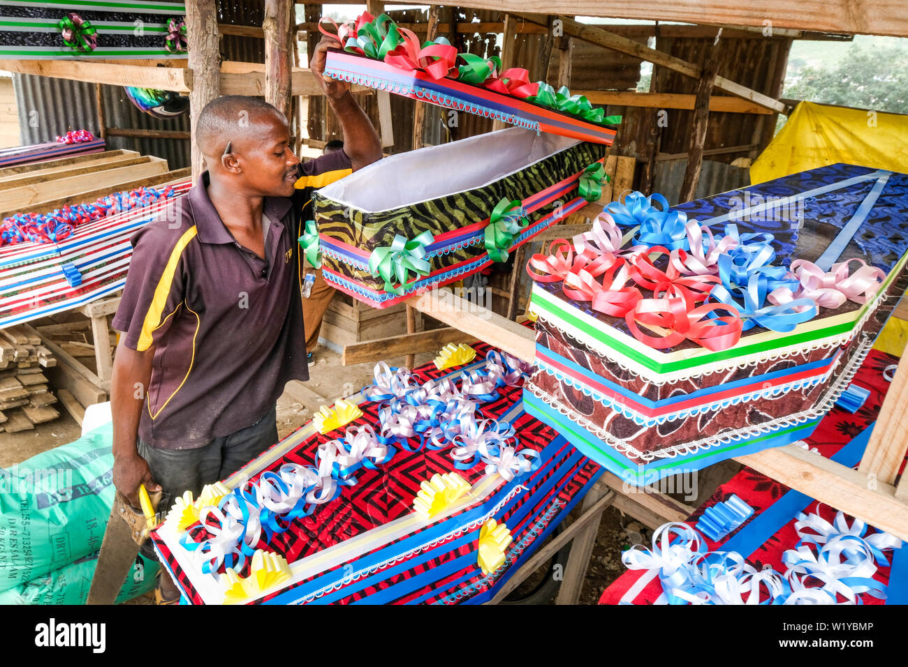 Coffin maker with decorated coffins at a market in Mbeya, Tanzania, Africa Stock Photo