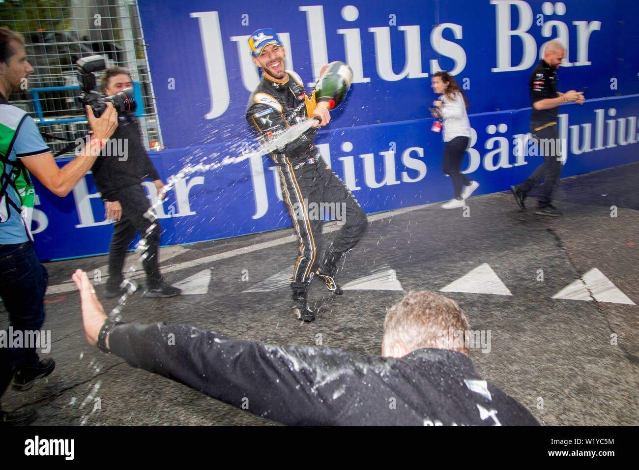 French race car driver Jean- Eric Vergne celebrate his victory of the ABB FIA Formula E race in Bern by spraying down his DS Techeetah team members with champagne. Stock Photo