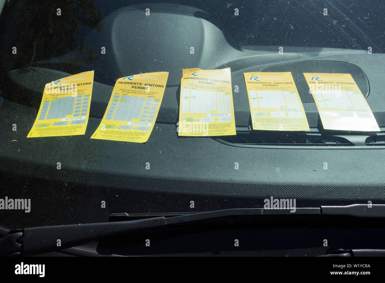 Multiple Residents' Visitors Permits on a dashboard in a car in London