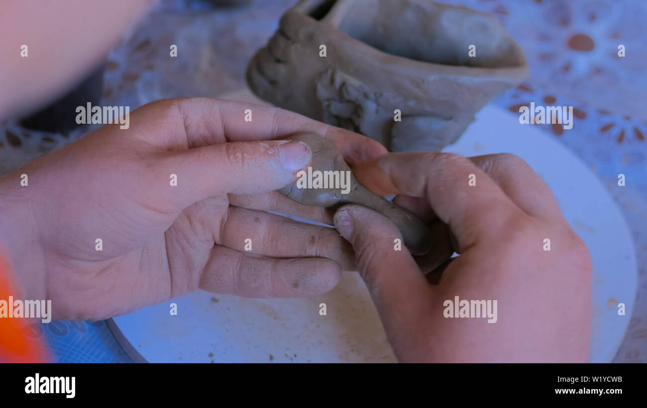 Man making mug in pottery studio workshop Stock Photo
