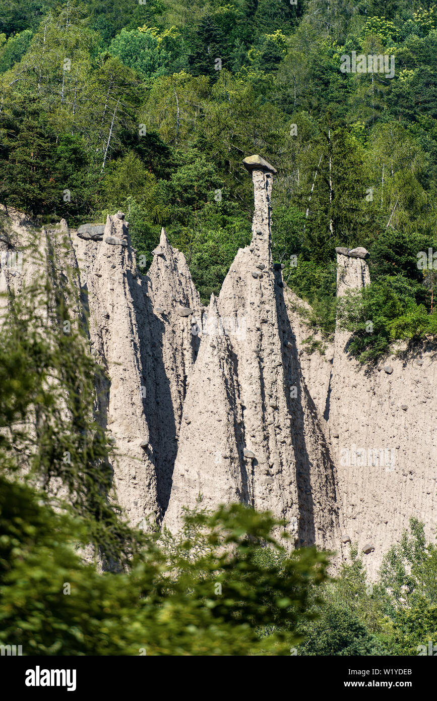 Pyramids of Segonzano (Piramidi di Segonzano), tall natural columns surmounted by a boulder of porphyry, Val di Cembra, Trentino Alto Adige, Italy Stock Photo